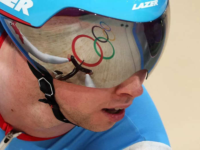 Jared C. Tilton sought the best angle to photograph the Olympic rings reflected in the Canadian cyclist Nick Wammes