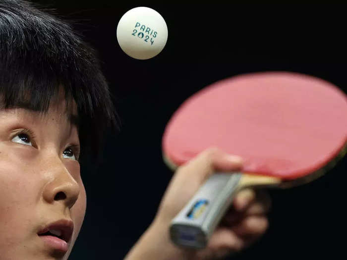 Steph Chambers waited until the Olympic logo was visible on a table-tennis ball to photograph the North Korean player Kum Yong Kim.