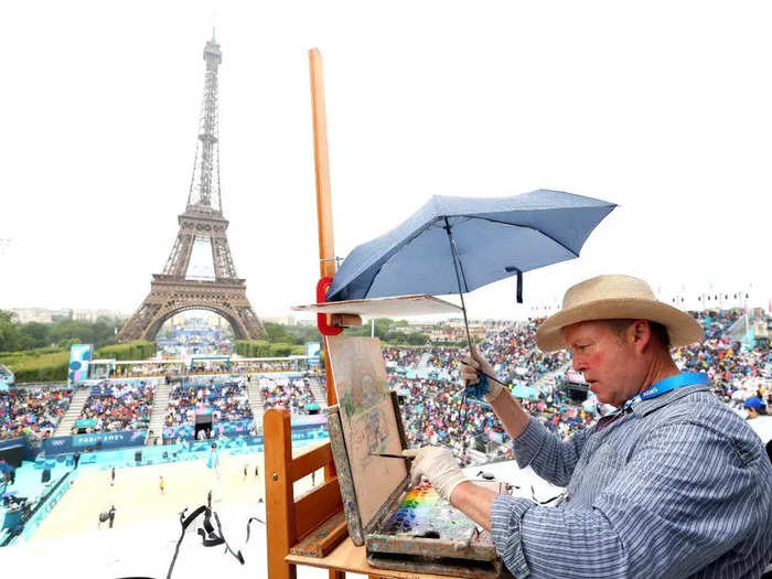 On the first day of the Olympics, Michael Reaves photographed Peter Spens, an artist commissioned to paint volleyball matches.