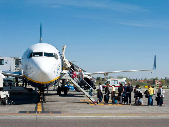 Greet staff members when you board the plane.