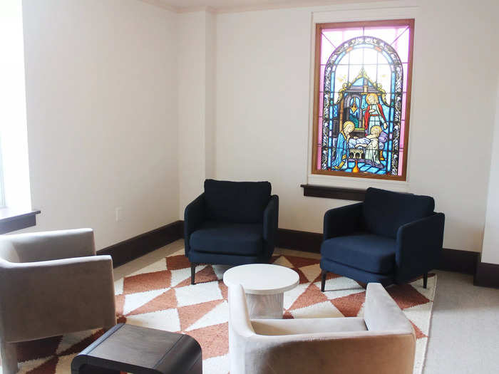 A sitting area by the entrance featured an original stained-glass window.