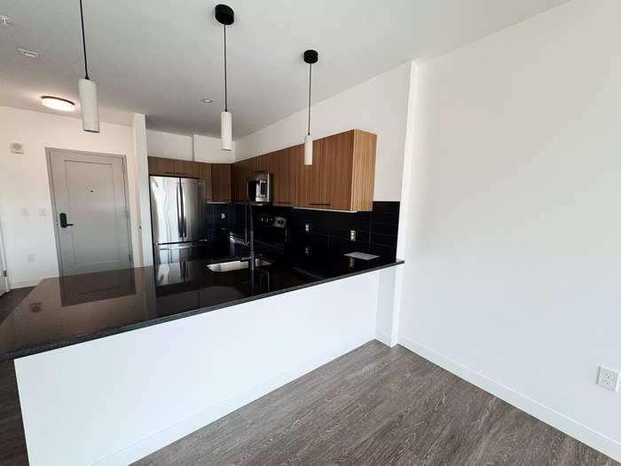 The kitchen was modern and spacious with wooden accents. 