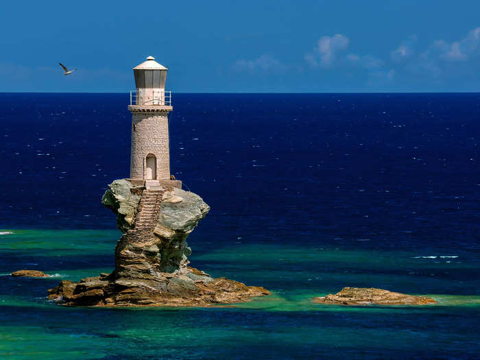 A winding stone staircase leads up to the Tourlitis Lighthouse in Greece.