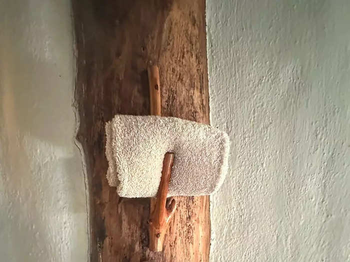 Extra towels were nestled in shelves made of branches. 