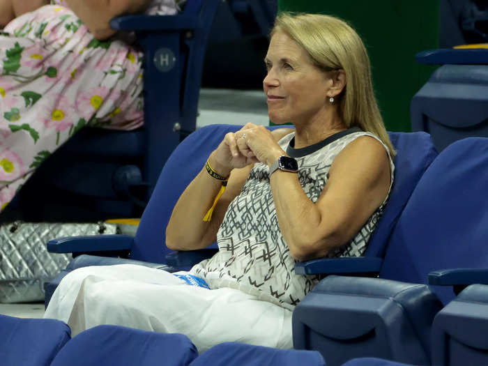 Legendary journalist Katie Couric wore a sleeveless patterned blouse and white maxi skirt on day one of the US Open.