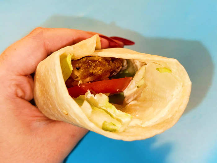 The classic wrap comes with a large chicken tender, lettuce, tomato, and Royal sauce in a white tortilla.