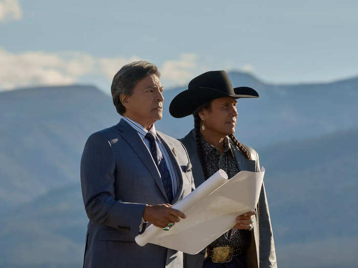 Thomas Rainwater (Gil Birmingham) and Moses (Mo Brings Plenty) consult plans while looking out into the Montana countryside.