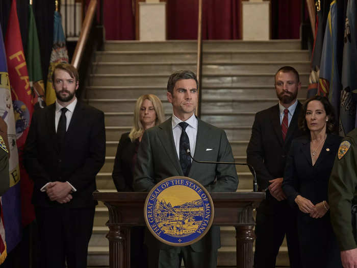 Jamie Dutton (Wes Bentley) delivers a speech, flanked by former governor Lynelle Perry (Wendy Moniz).