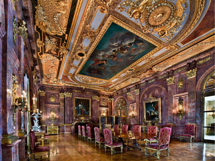 The purple marble walls in the dining room were created from single slabs cut in half lengthwise in a process called bookmatching.