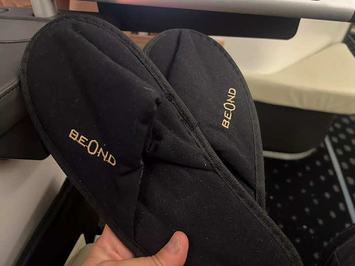 Travelers get slippers and an amenity kit.