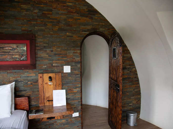 A small door led to a rock-walled bathroom. 