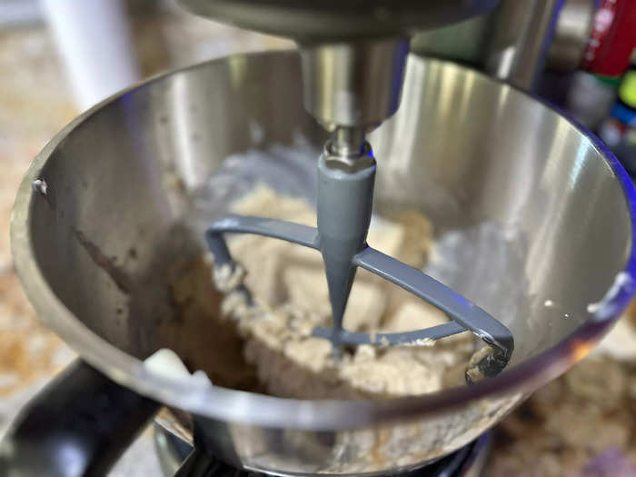 The first step is to combine the wet ingredients and sugars with a mixer.