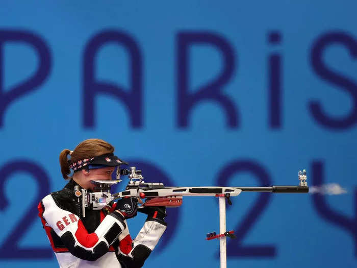 Dean Mouhtaropoulos framed his photo of German shooter Natascha Hiltrop with the Paris 2024 logo in the background.