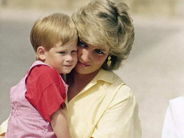 The Princess of Wales and Harry embraced while visiting the Royal Palace in Mallorca in August 1987.