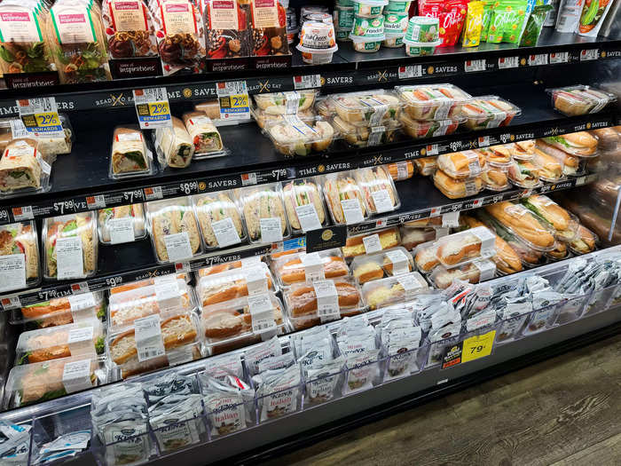 In the deli section, there was a case filled with sandwiches to grab and go.