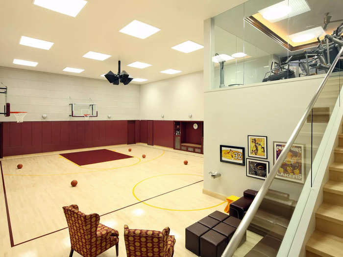 A gym that overlooks an indoor basketball court. The house also contains an indoor lap pool.