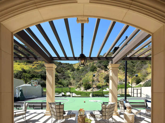 A full-size basketball court and golf greens on the grounds of a chateau-style Beverly Hills estate.