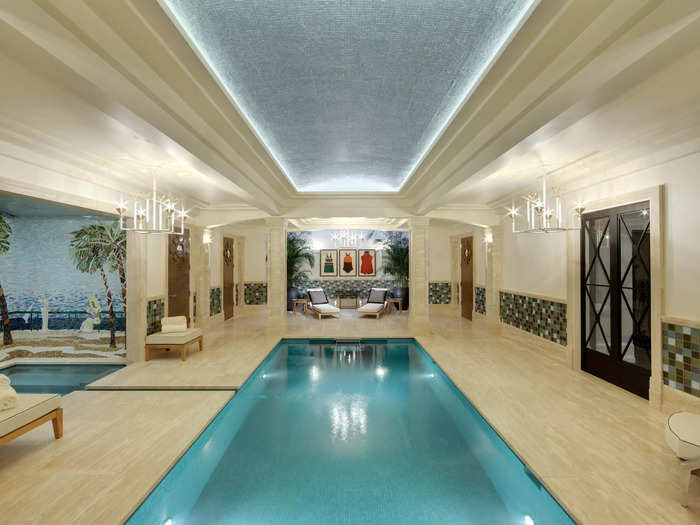 The underground spa of an Italian-villa-style home. It features a lap pool in the center of the room.