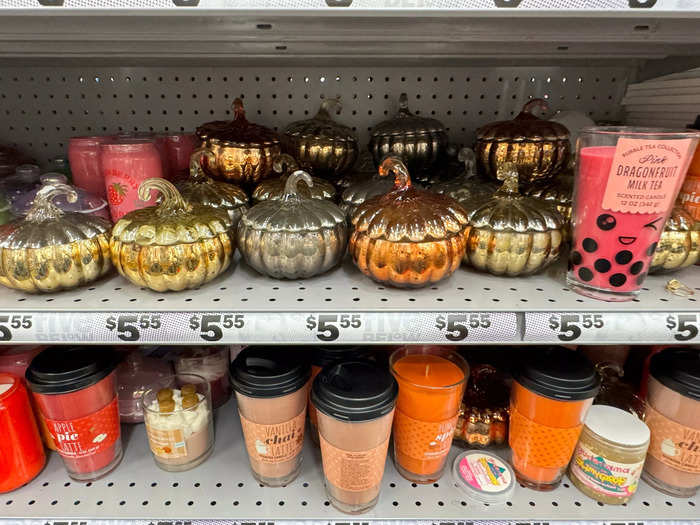 Among the display, there was an entire shelf filled with pumpkin-shaped candles.