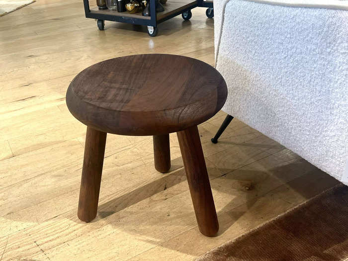 The rich tones in the Colin King acacia-wood side table add depth to any room.