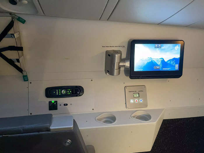 The pilots also had a TV similar to the one I had in business class near the recliner chairs. Nearby was a plug, temperature control panel, and cupholders.