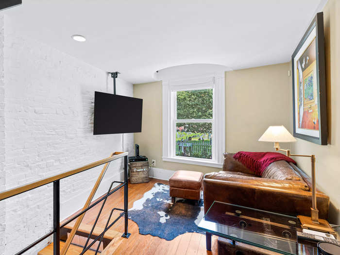 The second-floor sitting area has a window overlooking some greenery outside.