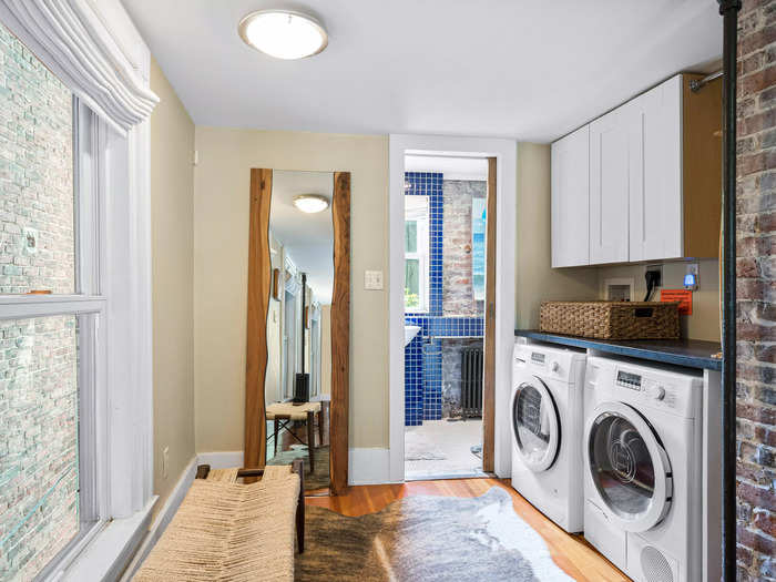 Upstairs, the second floor includes the bathroom, laundry room, and a sitting area.