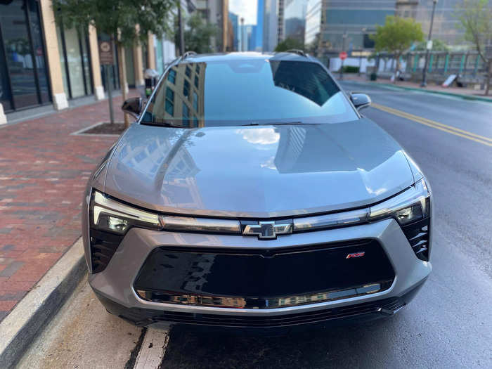 The front fascia is dominated by a large illuminated LED light bar that spans the width of the front end. 