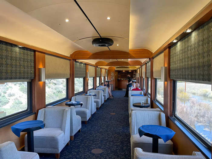 Behind the passenger car were exclusive lounge cars. Each one had a bar, and the first one I saw had a warm, midcentury modern theme.