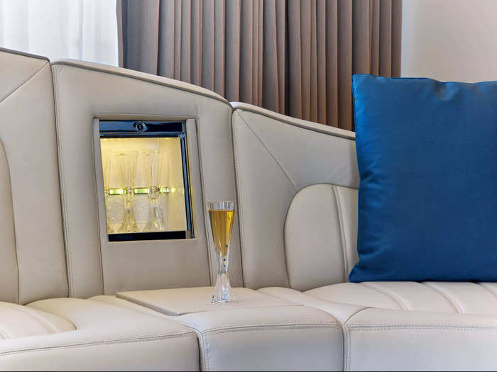 The curbed sofa also has a built-in Champagne bar.