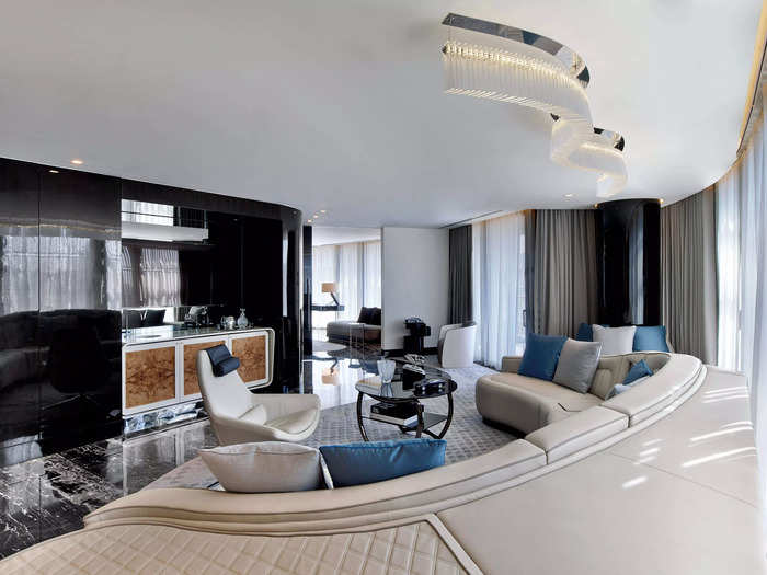 The suite includes a separate living room with a built-in curved sofa modeled after the luxurious cabins inside Bentley cars and upholstered with the brand