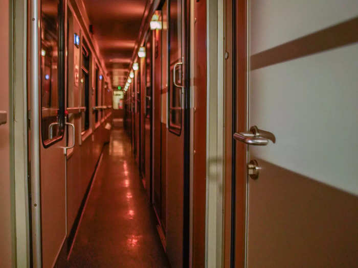 Inside the sleeper cars, I saw narrow, dimly lit corridors full of small cabins with bunk beds.