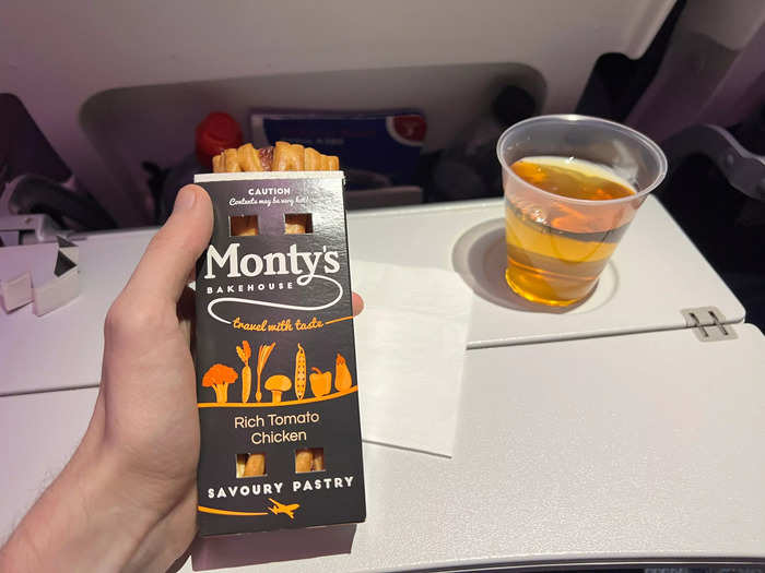 At the end of my economy flight, I had a chicken and tomato pastry and an apple juice.