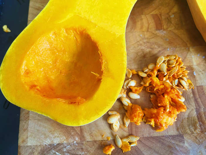 After cutting it in half, I removed the seeds from the hollowed-out part of the squash with a spoon.