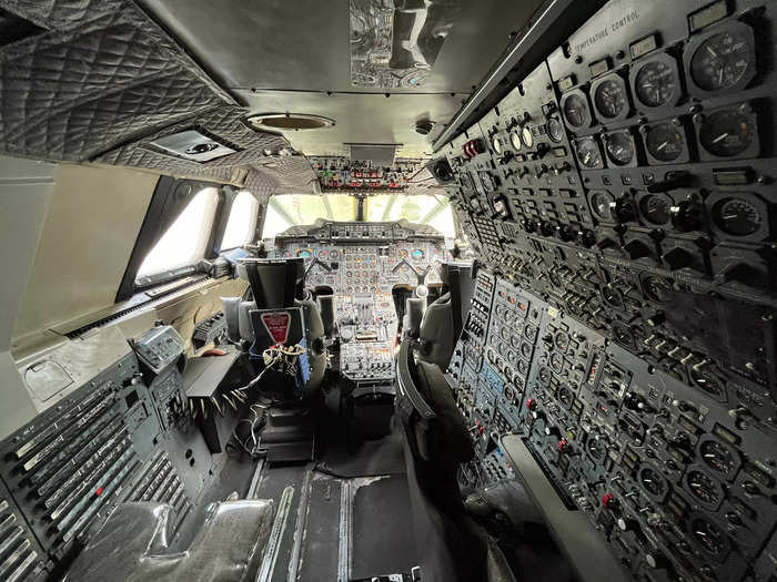 The flight engineer sat in the seat on the right in front of the large instrument panel.