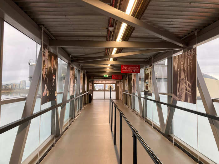 A walkway with more photos leads to the deck of the boat.