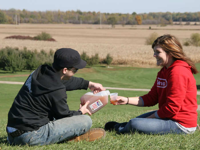 Visitors enjoy cider from a century-old mill in Michigan, where apples are big business.