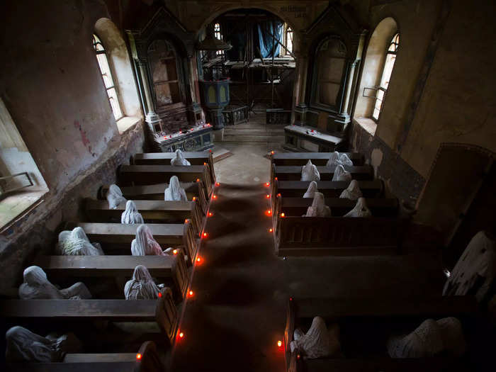 Other figures congregate near the altar and stand at the doorways.