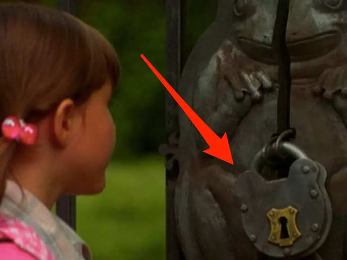 The frog-shaped lock on the fence contains a hidden Mickey.