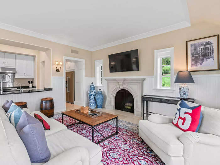 The living room has a fireplace and French doors that overlook the bay. 