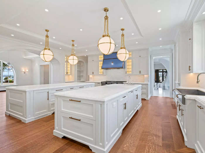 The main kitchen has two large islands and art deco-style light fixtures. 