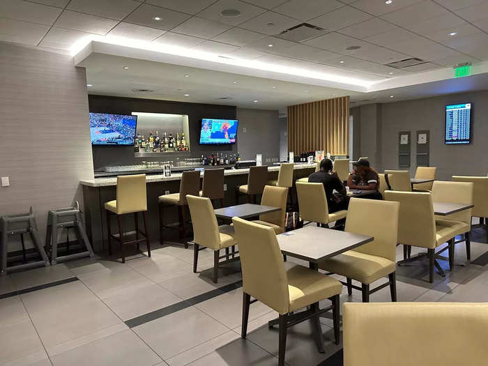 Each seating area in the lounge had several TVs displaying sports, news, and upcoming flight information.