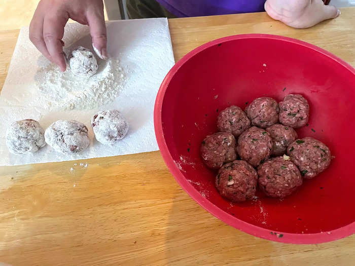 Pour the flour on a paper towel or plate, then gently roll each meatball in the flour to cover it. 