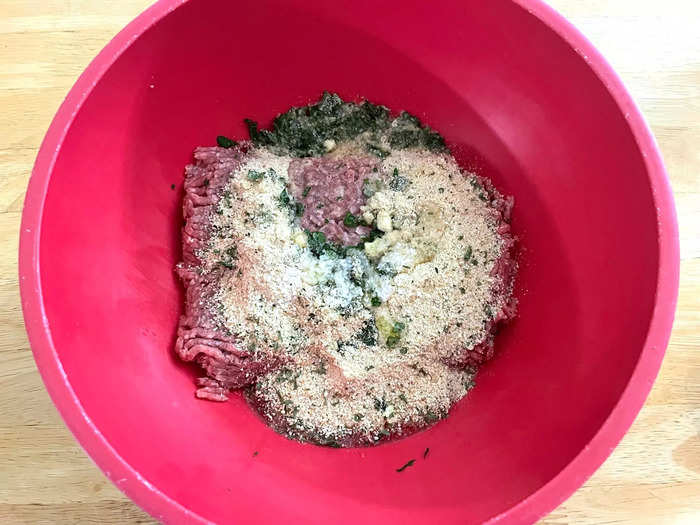 Throw the ground beef in a bowl with the chopped parsley, garlic, egg, and breadcrumbs, plus the salt and ⅛ cup of water.