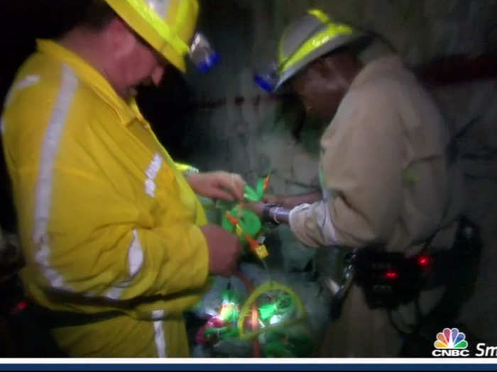 Others prepare to blow away rock with dynamite.