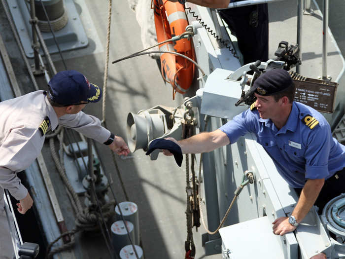 The Brits also sailed in support of the mission and offered the Japanese Captain a hat during this lull in the maneuvers