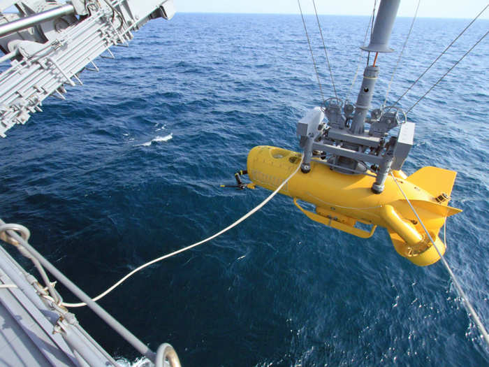 From there the massive crane spools out the cable needed to slip the drone into the warm waters of the Persian Gulf