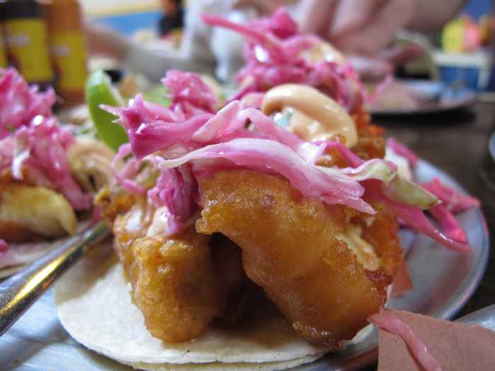 Mexico brings us a crispy fish taco. The fish is tilapia, battered and fried, topped with chipotle mayonnaise and red cabbage.