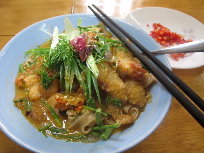 Vietnam brings us Banh Da (shrimp and fish) noodles in a shrimp-based broth. The fish is crisped and served on top.