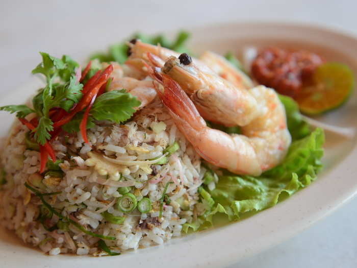 Rice mixed with different herbs, leaves, and toasted coconut make up this favorite Malaysian dish known as Nasi Ulam. Here it